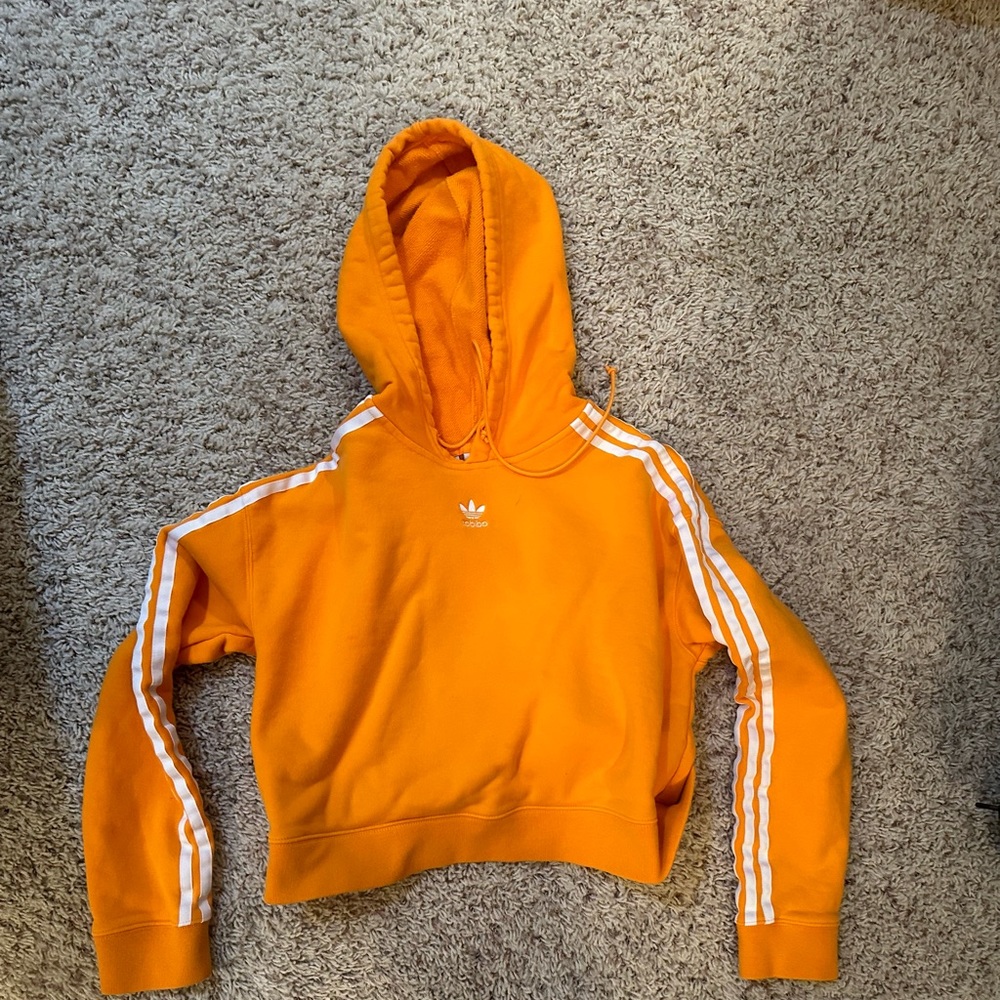 Size extra small women’s Adidas cropped hoodie in excellent condition.  Orange.